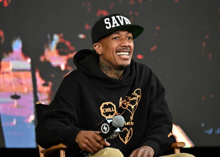 Nick cannon savage hat black hoodie smiling