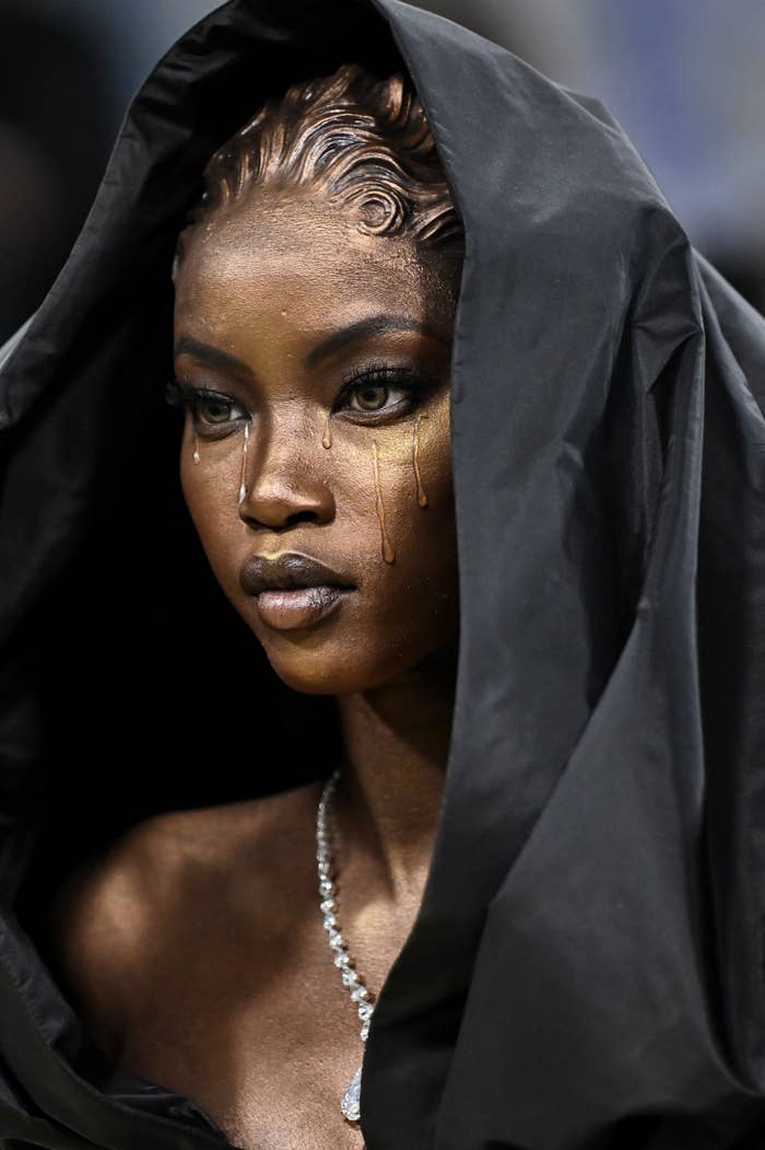 anok yai gold makeup hooded fashion editorial