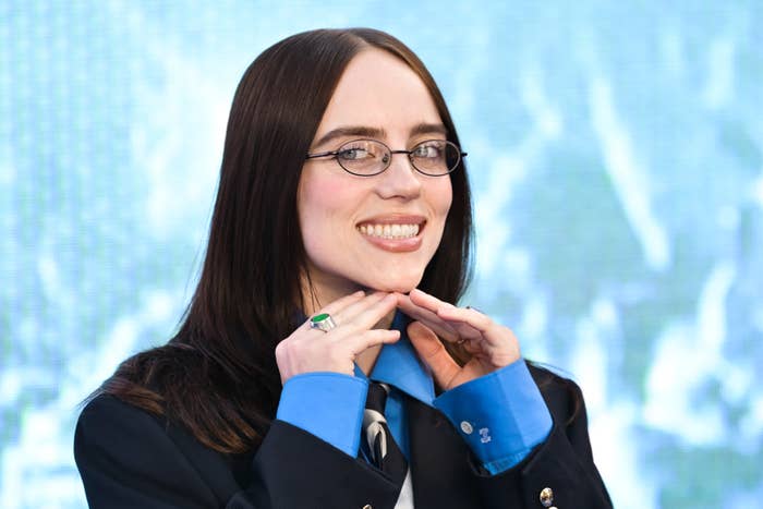 billie eilish smiling blue shirt glasses