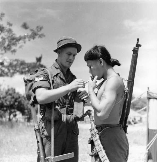 british soldier lighting dyak warrior cigarette
