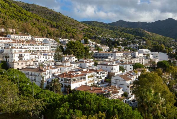 coastal village white houses mountainside