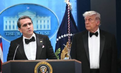 donald trump and man in tuxedos white house podium