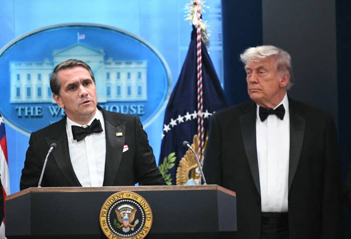 donald trump and man in tuxedos white house podium