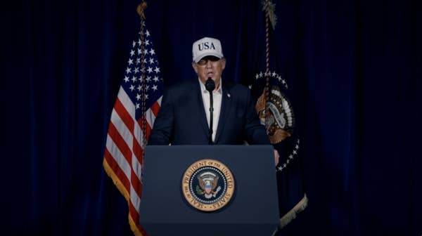 donald trump wearing usa hat podium
