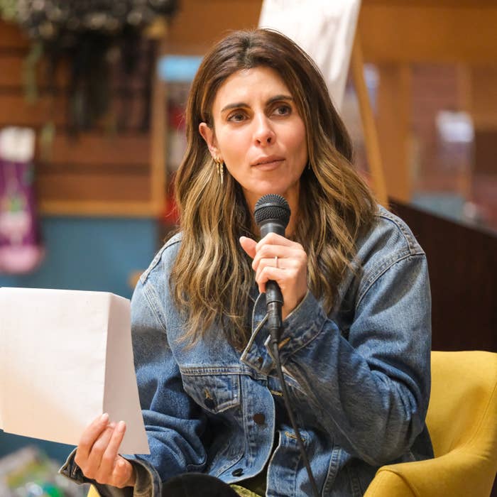 jamie lynn sigler speaking into microphone denim jacket