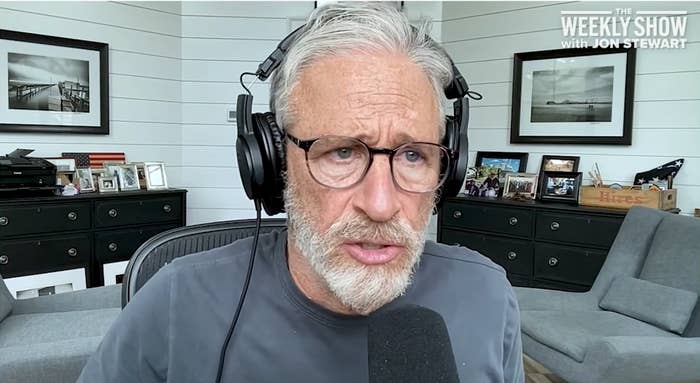 jon stewart wearing headphones serious