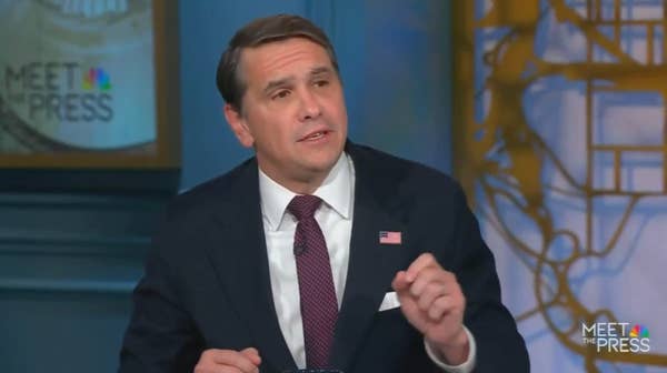 man gesturing during televised political discussion