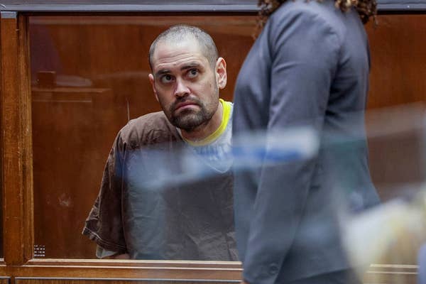 man in courtroom hearing brown shirt