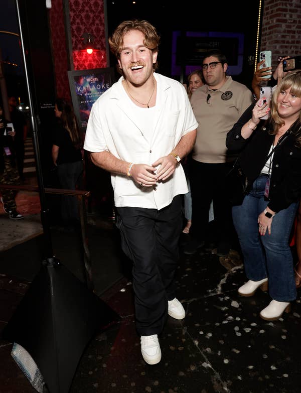 man in white short sleeve button down at event