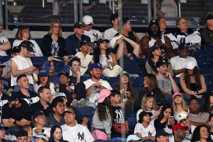man in white tshirt at baseball stadium crowd