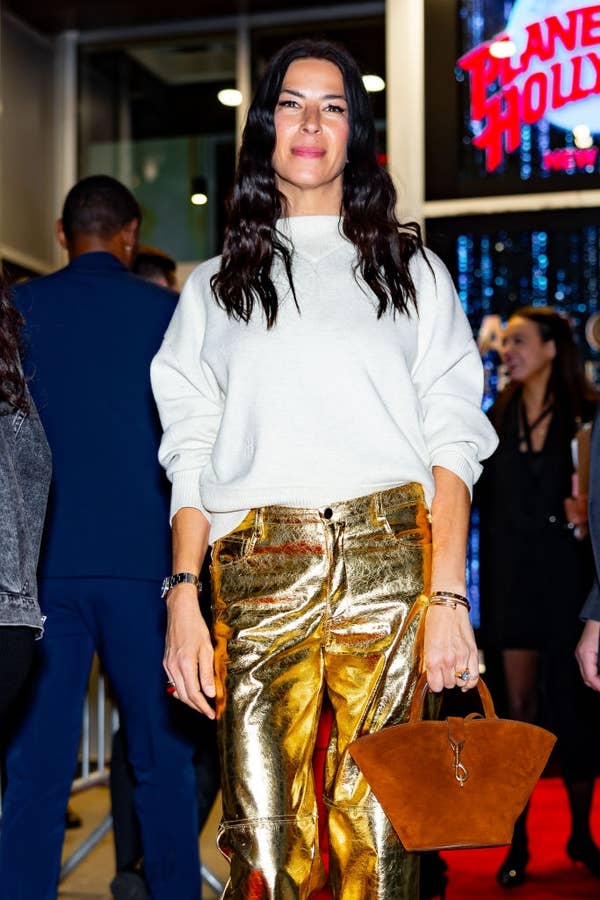 monica bellucci white sweater gold pants planet hollywood.jpg