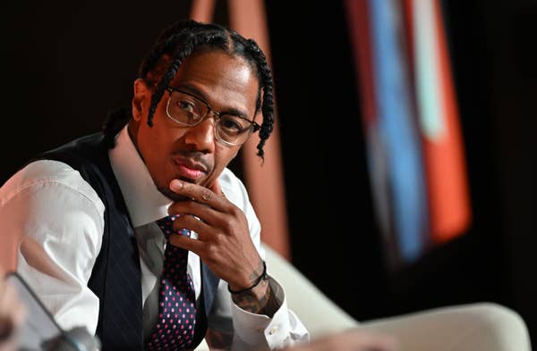 nick cannon glasses waistcoat thinking.jpg