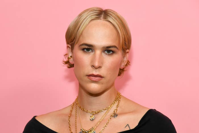 portrait blonde woman gold necklaces pink background.jpg