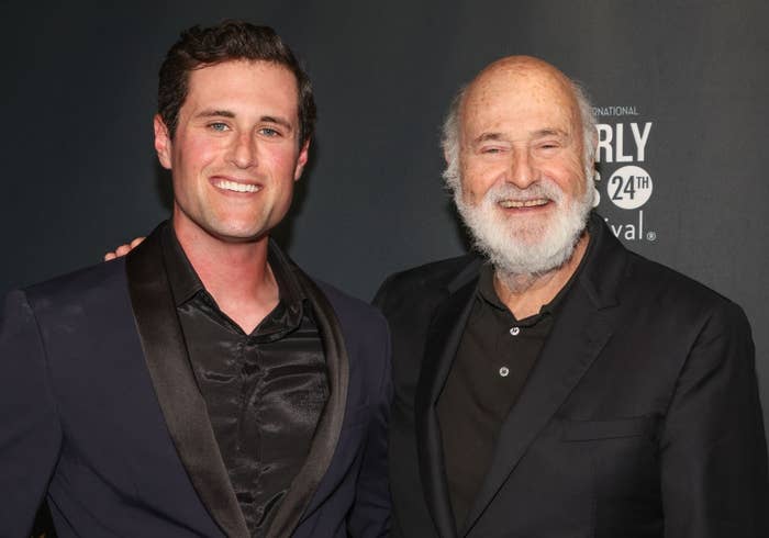 rob reiner and companion smiling at event