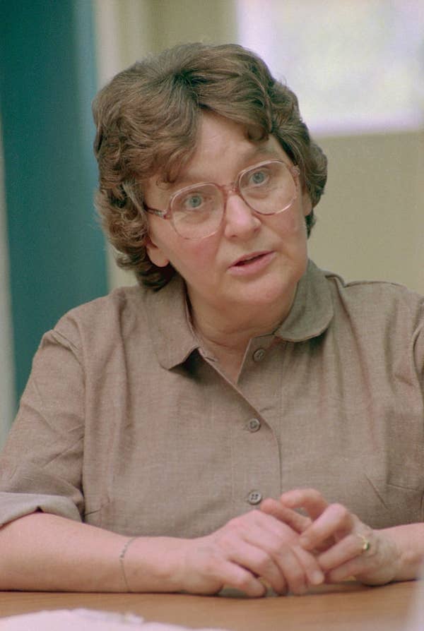 senior woman wearing glasses brown shirt