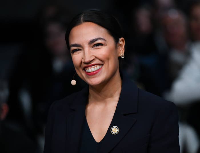 smiling alexandria ocasio cortez portrait navy suit.jpg