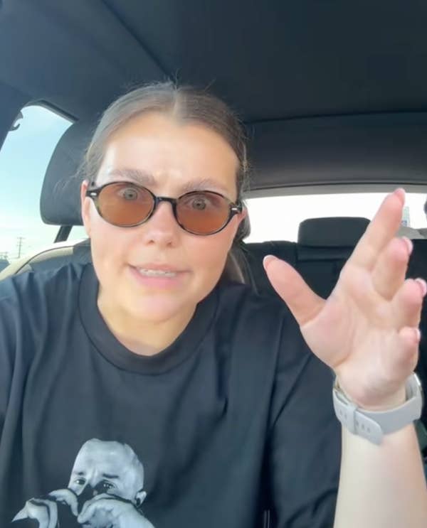 woman explaining with hand gestures in car
