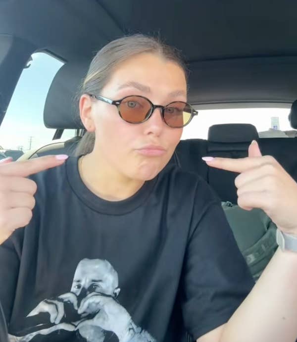 woman pointing to self with index fingers