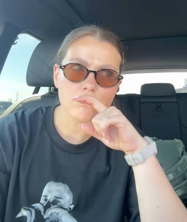 woman with sunglasses thinking gesture